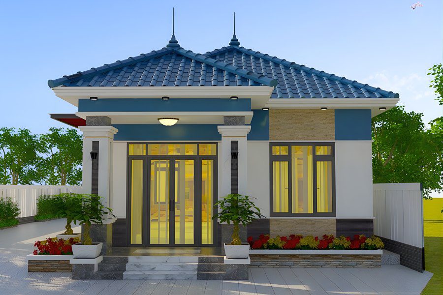 Mẫu nhà cấp 4 mái Nhật mini với mặt tiền trắng xanh, cột trụ ốp đá và bồn hoa trang trí.